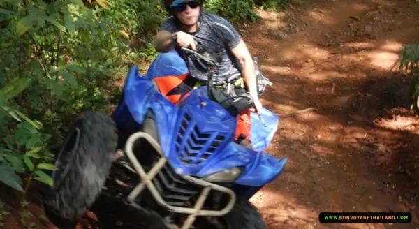 man enjoying driving atv on dirt road