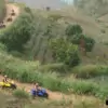 group of people enjoying driving atv on dirt road in mountain