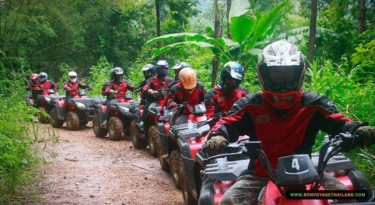 group of people enjoying driving atv on dirt road