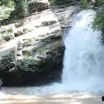 Mae Wang Waterfall with men looking at it