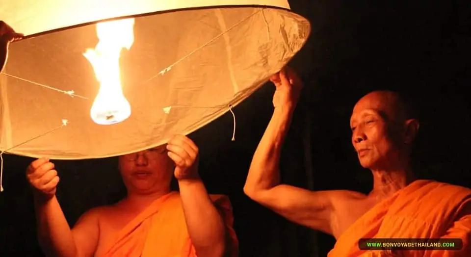 Monks floating a lantern