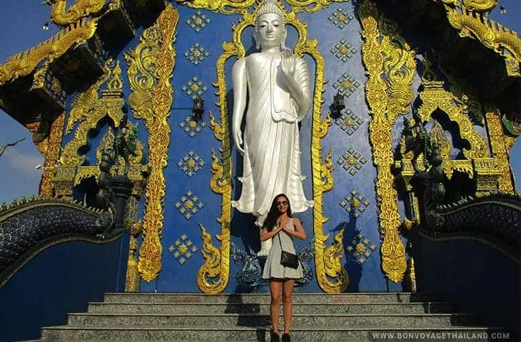 Women posing with Standing Buddha at the Blue Temple